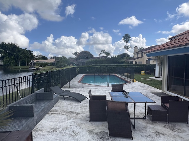 view of pool featuring a water view and a patio area