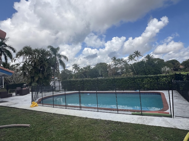 view of swimming pool with a yard and a patio area