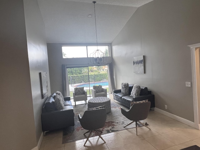 tiled living room with a chandelier and high vaulted ceiling