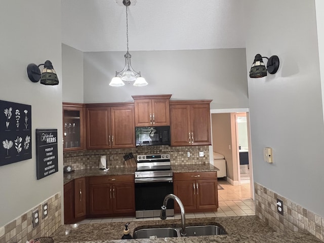 kitchen featuring tasteful backsplash, sink, stainless steel electric range, and hanging light fixtures