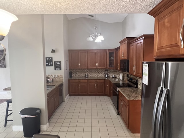 kitchen with a kitchen bar, stainless steel refrigerator, a notable chandelier, electric stove, and backsplash