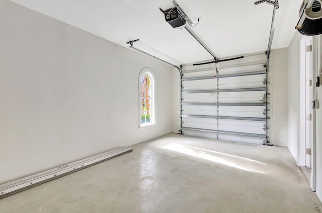 garage with a garage door opener and a baseboard heating unit