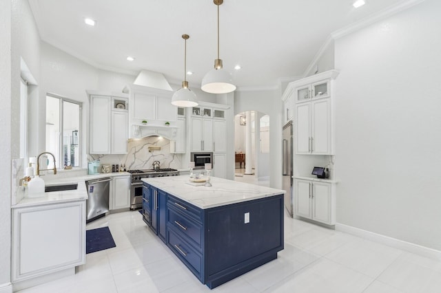 kitchen with a kitchen island, blue cabinetry, stainless steel appliances, and white cabinets