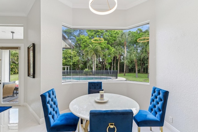 dining area featuring ornamental molding and plenty of natural light