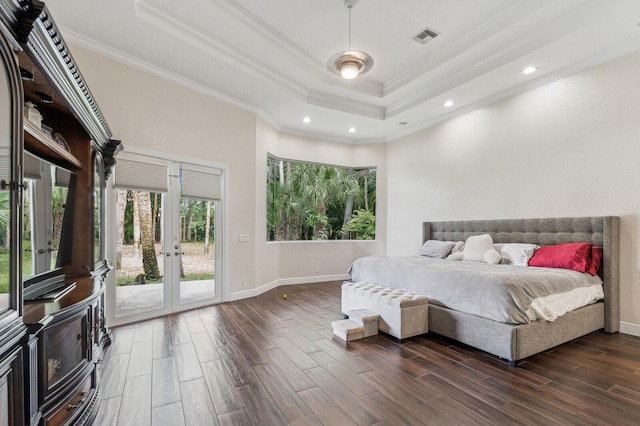 bedroom with french doors, dark hardwood / wood-style flooring, access to exterior, a tray ceiling, and ornamental molding