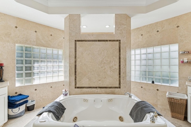 bathroom featuring vanity, a tub to relax in, and ornamental molding