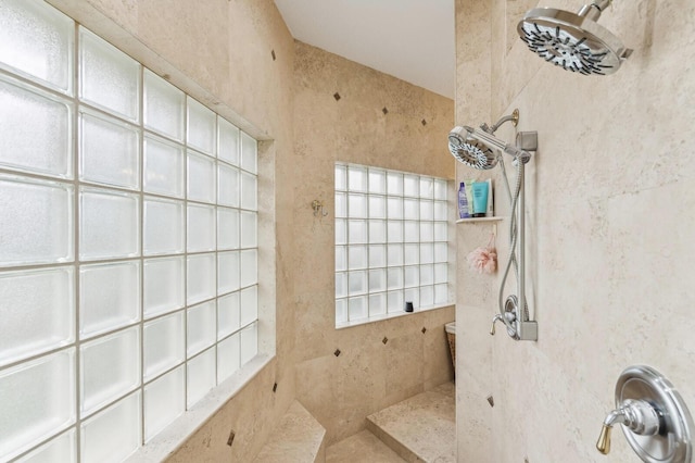 bathroom with a tile shower