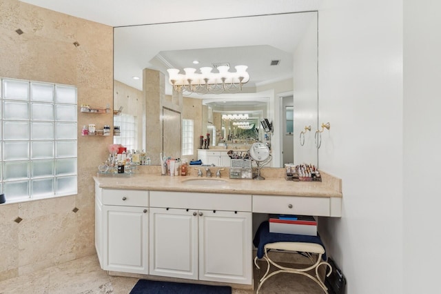 bathroom featuring vanity, crown molding, and plenty of natural light