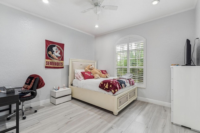 bedroom with ceiling fan, ornamental molding, and light hardwood / wood-style floors