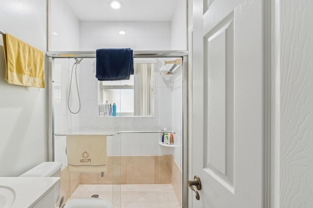 bathroom with toilet, vanity, and walk in shower