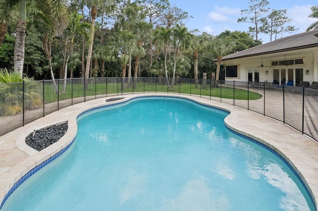 view of swimming pool with a patio and ceiling fan