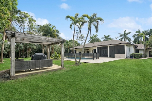 exterior space with a patio area, outdoor lounge area, a fenced in pool, a pergola, and a sunroom