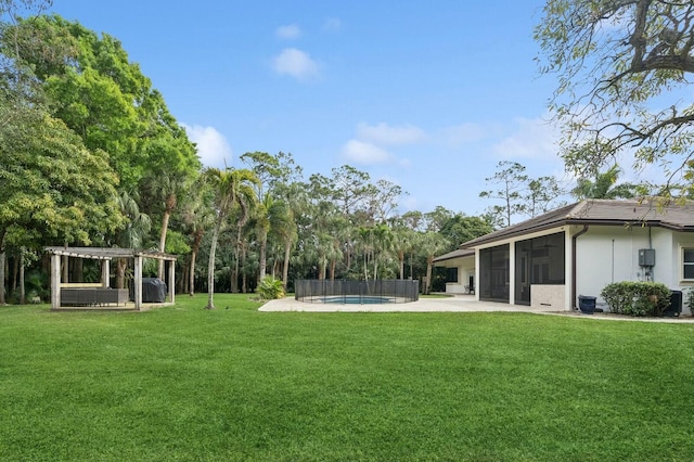 view of yard with a pergola, a patio area, and a sunroom