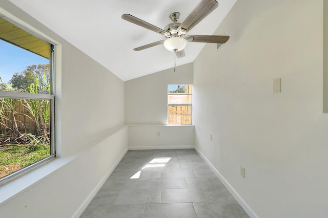 spare room featuring vaulted ceiling, ceiling fan, and light tile patterned flooring