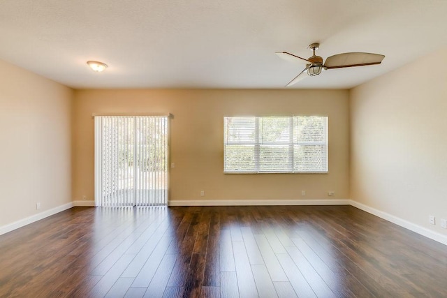 spare room with ceiling fan, dark hardwood / wood-style flooring, and a wealth of natural light