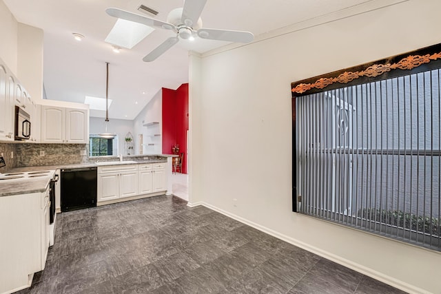 kitchen featuring black appliances, kitchen peninsula, vaulted ceiling with skylight, decorative backsplash, and white cabinets