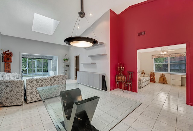 living room with a skylight, high vaulted ceiling, and light tile patterned floors