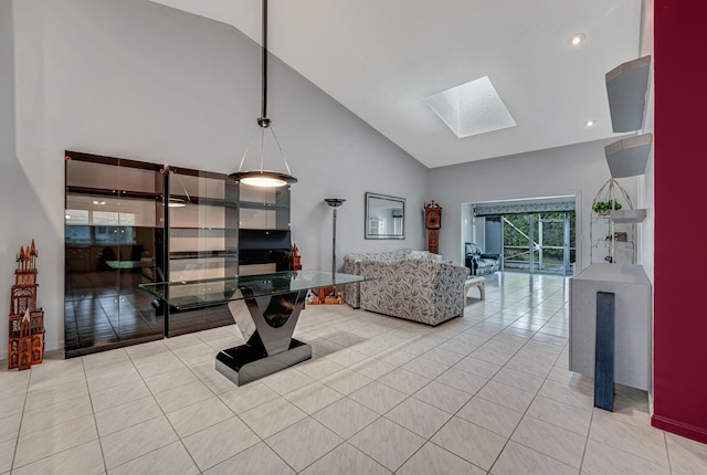 tiled living room featuring a skylight and high vaulted ceiling