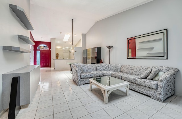 living room with vaulted ceiling and light tile patterned floors