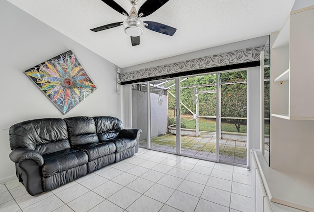 living room with ceiling fan, a textured ceiling, and light tile patterned floors