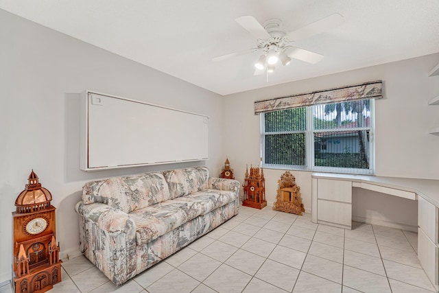 living room featuring light tile patterned flooring, ceiling fan, and built in desk