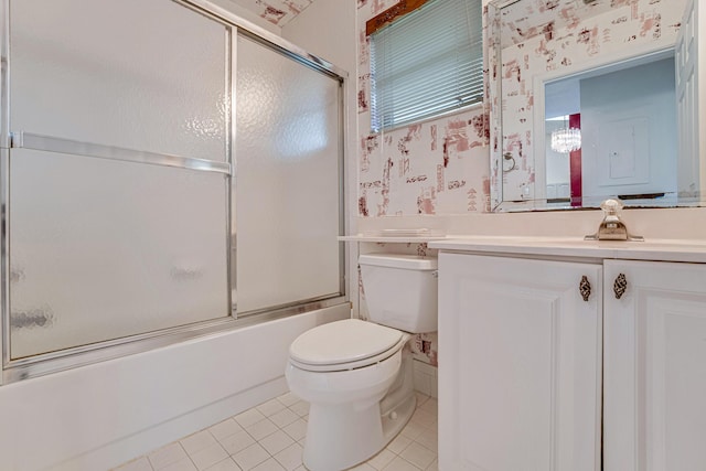 full bathroom featuring tile patterned flooring, enclosed tub / shower combo, vanity, and toilet