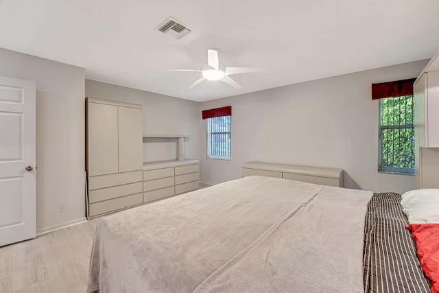 bedroom featuring multiple windows, ceiling fan, and light hardwood / wood-style floors