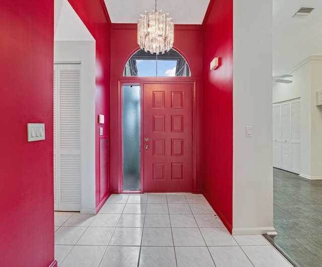 tiled entrance foyer featuring a chandelier