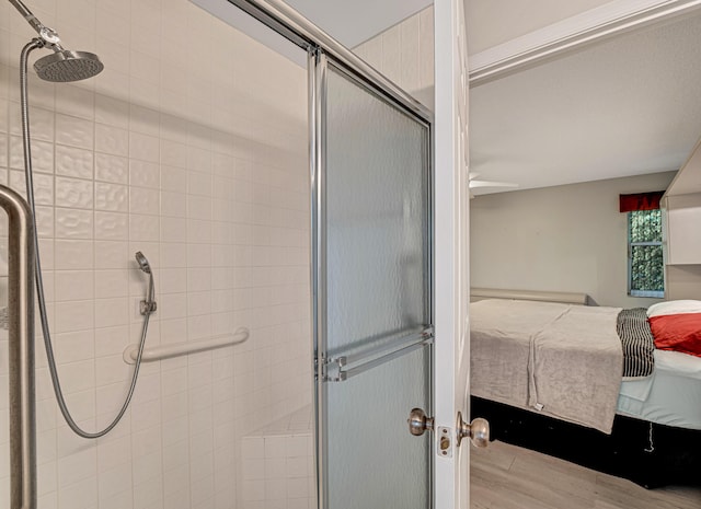 bathroom featuring an enclosed shower and wood-type flooring