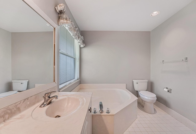 bathroom featuring tile patterned floors, toilet, a bath, and vanity