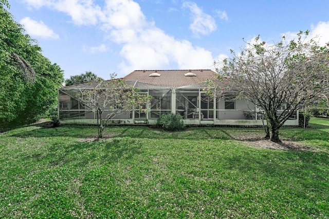 back of property featuring a yard and a lanai