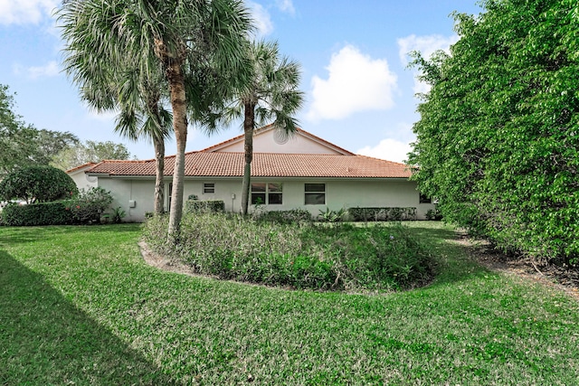 view of side of home with a lawn