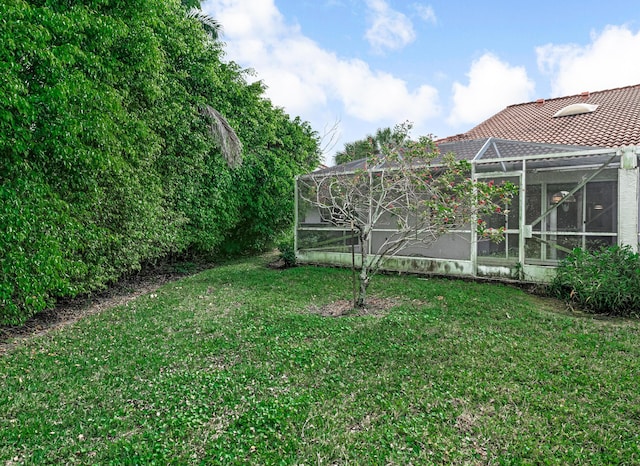 view of yard featuring glass enclosure