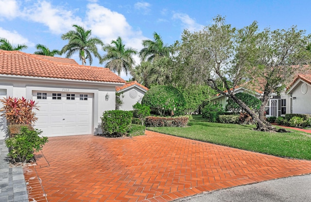 view of front of property featuring a garage and a front yard