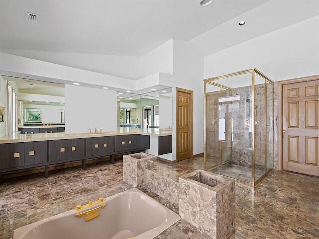 bathroom featuring lofted ceiling, vanity, and independent shower and bath