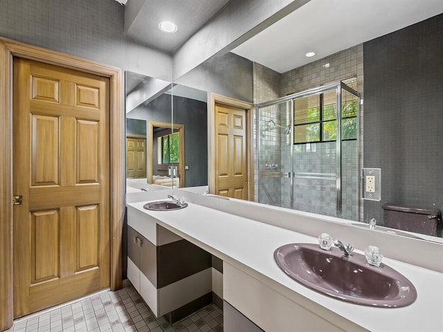 bathroom with vanity, an enclosed shower, and tile patterned floors