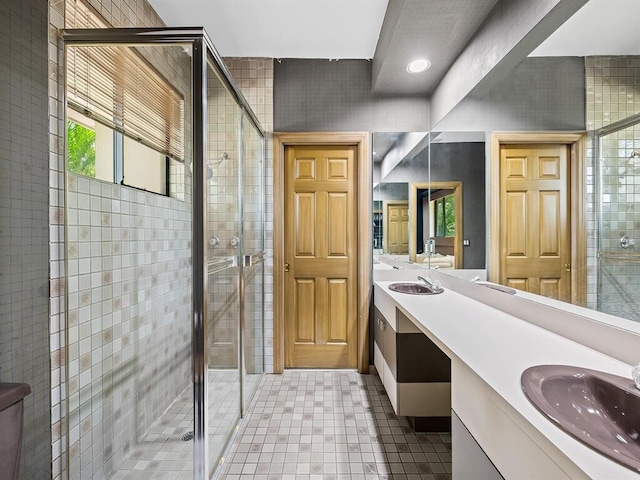 bathroom with vanity, tile patterned flooring, and a shower with door