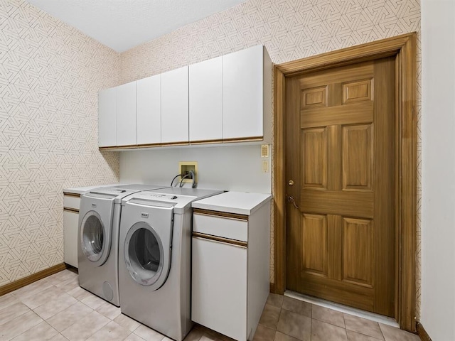 washroom with light tile patterned flooring, cabinets, and separate washer and dryer