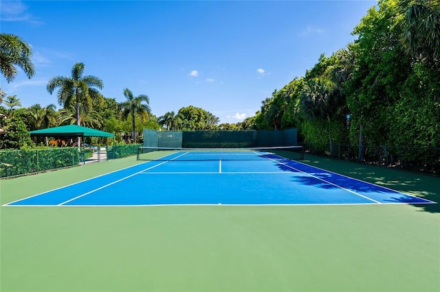 view of tennis court featuring basketball hoop