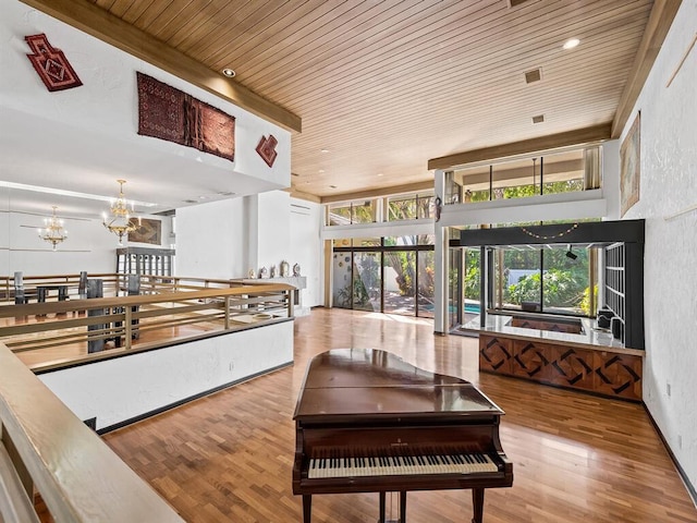 interior space with an inviting chandelier, hardwood / wood-style floors, and wooden ceiling