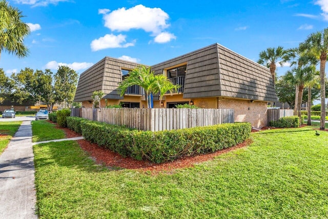 view of side of property with a lawn