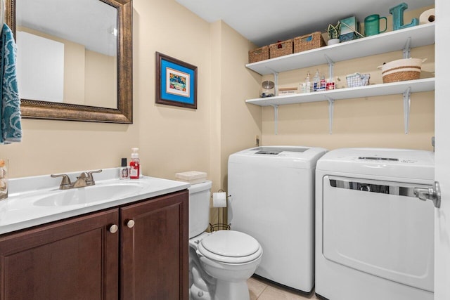 bathroom featuring separate washer and dryer, vanity, tile patterned floors, and toilet