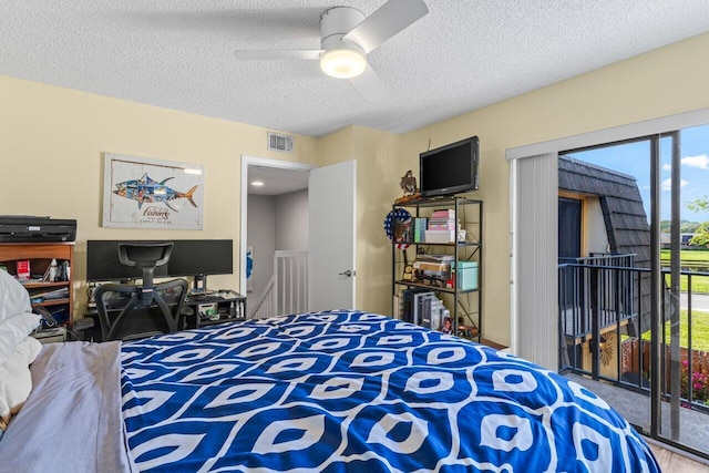 bedroom with ceiling fan, a textured ceiling, and access to outside