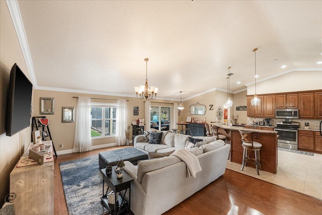 living room featuring lofted ceiling, a notable chandelier, crown molding, and dark wood-type flooring