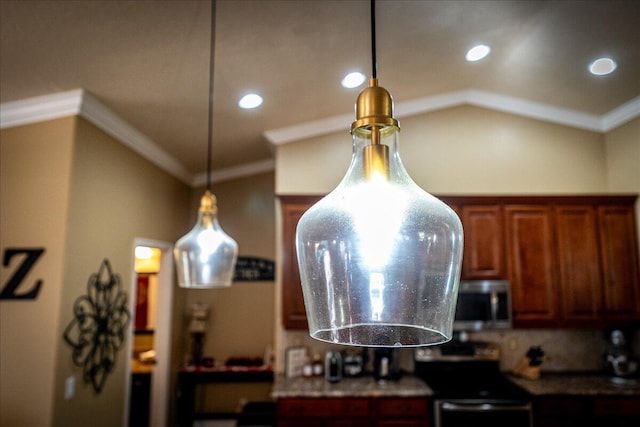 kitchen with ornamental molding, vaulted ceiling, and decorative light fixtures