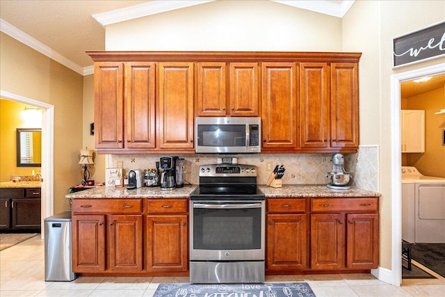 kitchen featuring crown molding, stainless steel appliances, light stone counters, and decorative backsplash