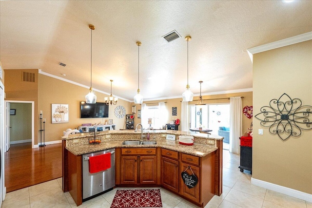 kitchen featuring sink, hanging light fixtures, dishwasher, and a center island with sink