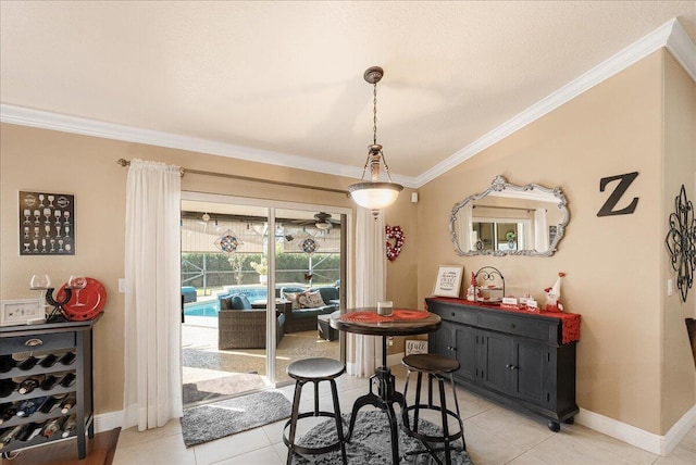 dining area featuring ornamental molding and light tile patterned floors