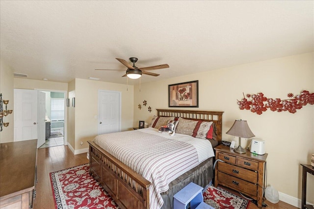 bedroom with wood-type flooring, ceiling fan, and a textured ceiling