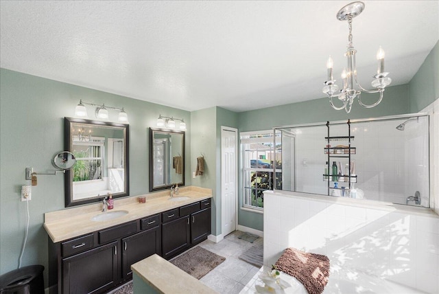 bathroom featuring vanity, a chandelier, a textured ceiling, and walk in shower